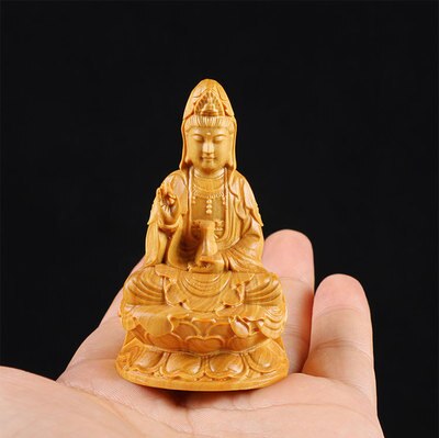 statue bouddha assis en bois sur une amin
