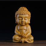 statue bébé bouddha foncé
