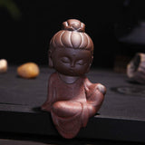 statue bouddha méditation rouge coiffé