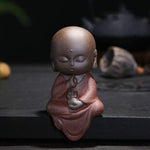 statue bouddha méditation rouge chauve