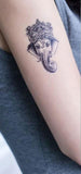 tatouage bouddha ganesh sur un bras